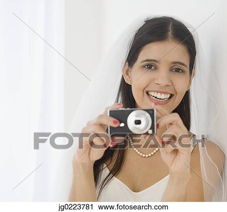 Hispanic bride taking photograph View Large Photo Image Stock Image - Hispanic bride taking photograph. Fotosearch