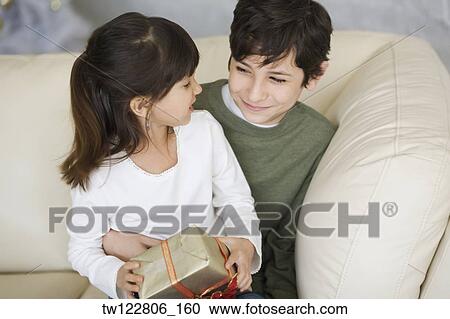 Hispanic brother and sister holding Christmas gift View Large Photo Image Stock Image - Hispanic brother and sister holding Christmas gift. Fotosearch