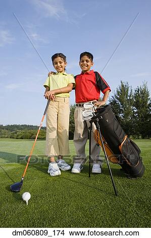 Hispanic brother and sister on golf course View Large Photo Image Picture - Hispanic brother and sister on golf course. Fotosearch