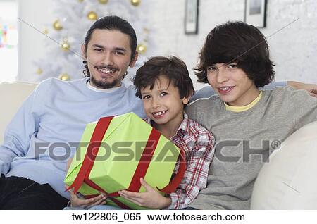 Hispanic brothers holding Christmas gift View Large Photo Image Stock Photography - Hispanic brothers holding Christmas gift. Fotosearch