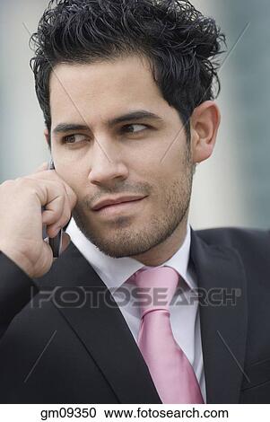 Hispanic businessman talking on cell phone View Large Photo Image Stock Image - Hispanic businessman talking on cell phone. Fotosearch