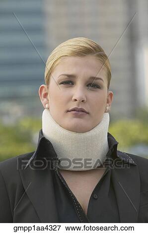 Stock Photo - Hispanic businesswoman wearing neck brace. Fotosearch