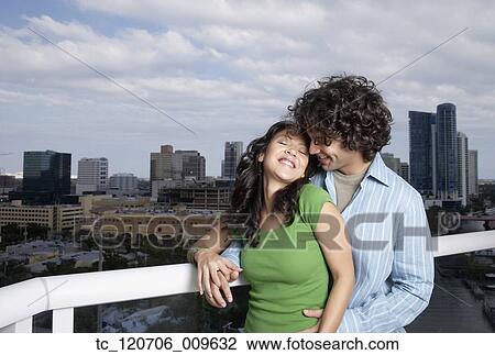 Hispanic couple hugging on balcony View Large Photo Image Stock Image - Hispanic couple hugging on balcony. Fotosearch