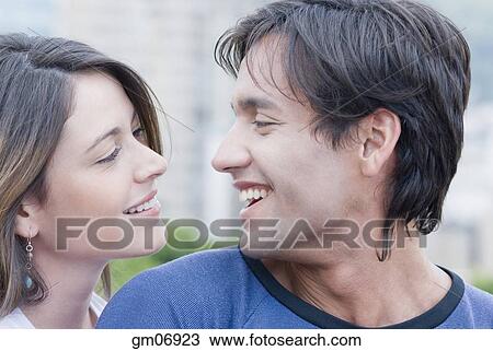 Hispanic couple smiling at each other View Large Photo Image Stock Image - Hispanic couple smiling at each other. Fotosearch