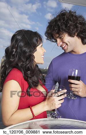 Hispanic couple smiling at each other View Large Photo Image Stock Image - Hispanic couple smiling at each other. Fotosearch