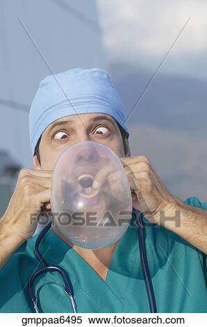 Hispanic doctor blowing up condom View Large Photo Image Stock Photography - Hispanic doctor blowing up condom. Fotosearch