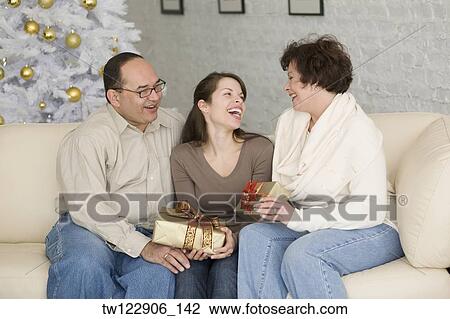 Hispanic family exchanging gifts on Christmas View Large Photo Image Stock Image - Hispanic family exchanging gifts on Christmas. Fotosearch