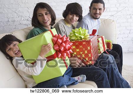 Hispanic family holding gifts View Large Photo Image Stock Photo - Hispanic family holding gifts . Fotosearch