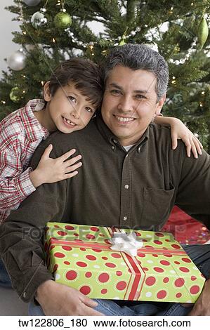 Stock Image - Hispanic father and son on Christmas. Fotosearch