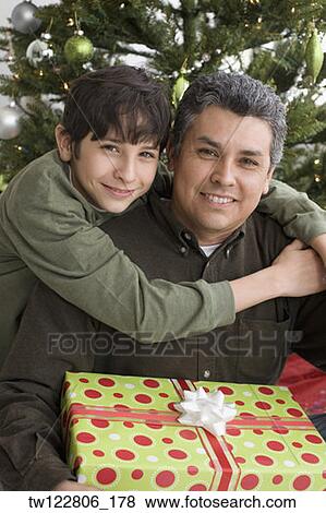 Hispanic father and son on Christmas View Large Photo Image Stock Photo - Hispanic father and son on Christmas. Fotosearch