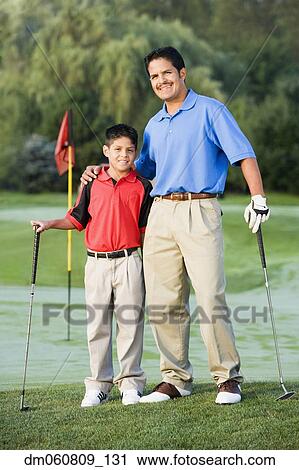 Hispanic father and son on hugging on golf course View Large Photo Image Stock Image - Hispanic father and son on hugging on golf course. Fotosearch