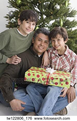 Hispanic father and sons on Christmas View Large Photo Image Stock Photograph - Hispanic father and sons on Christmas. Fotosearch