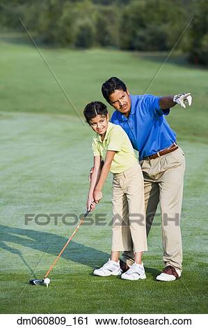Hispanic father helping daughter play golf View Large Photo Image Stock Image - Hispanic father helping daughter play golf. Fotosearch