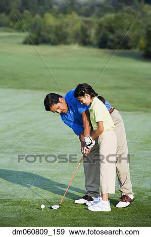 Hispanic father helping daughter play golf View Large Photo Image Stock Photo - Hispanic father helping daughter play golf. Fotosearch