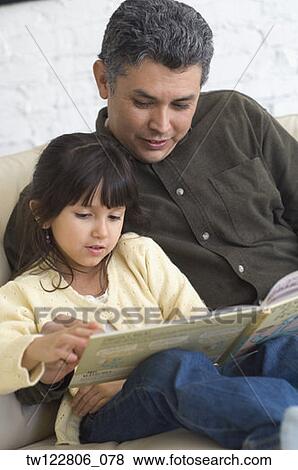 Hispanic father reading to daughter View Large Photo Image Stock Photo - Hispanic father reading to daughter. Fotosearch