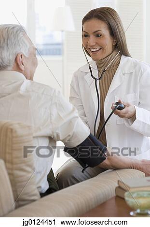 Hispanic female doctor taking patient’s blood pressure View Large Photo Image Stock Image - Hispanic female doctor taking patient’s blood pressure. Fotosearch