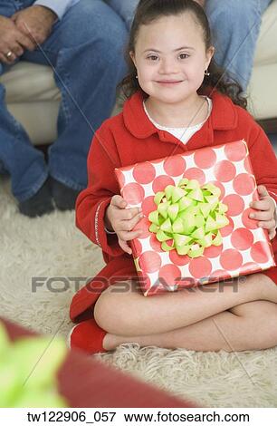 Hispanic girl holding gift View Large Photo Image Stock Photo - Hispanic girl holding gift. Fotosearch