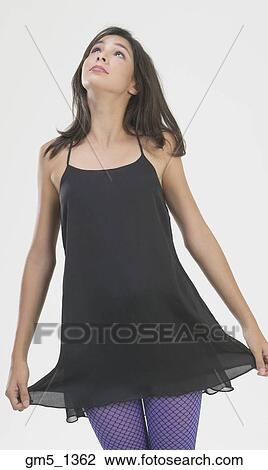 Hispanic girl holding hem of minidress View Large Photo Image Stock Image - Hispanic girl holding hem of minidress. Fotosearch