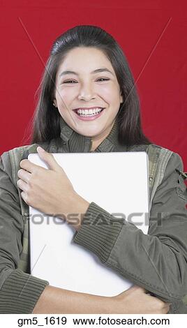 Hispanic girl hugging laptop View Large Photo Image Stock Photo - Hispanic girl hugging laptop. Fotosearch