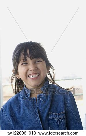 Stock Image - Hispanic girl laughing. Fotosearch