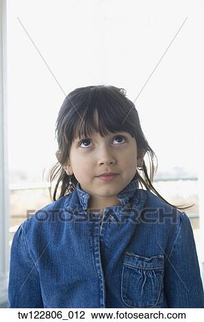 Stock Image - Hispanic girl looking up. Fotosearch