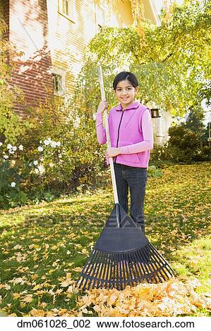 Hispanic girl raking leaves View Large Photo Image Stock Image - Hispanic girl raking leaves. Fotosearch