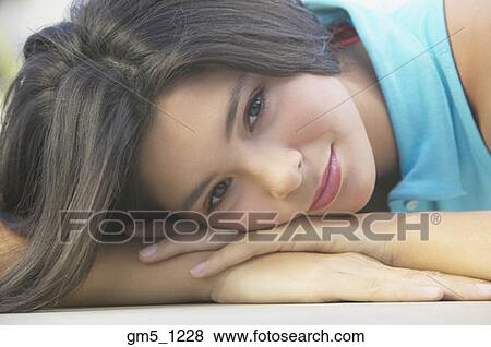 Hispanic girl resting head on hands View Large Photo Image Stock Photo - Hispanic girl resting head on hands. Fotosearch