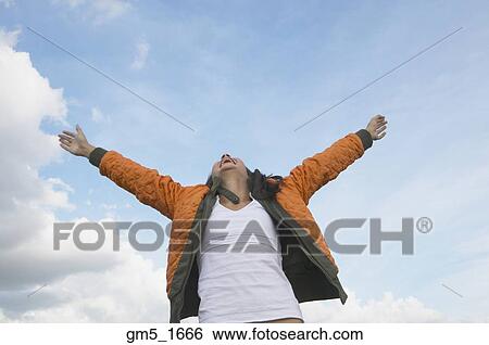 Stock Photograph - Hispanic girl with arms outstretched. Fotosearch