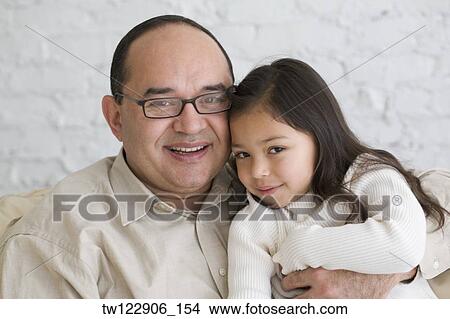 Hispanic grandfather and granddaughter hugging View Large Photo Image Picture - Hispanic grandfather and granddaughter hugging. Fotosearch