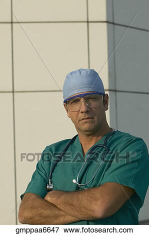 Hispanic male doctor with arms crossed View Large Photo Image Stock Photo - Hispanic male doctor with arms crossed. Fotosearch