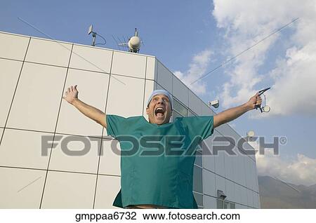 Hispanic male doctor with arms outstretched View Large Photo Image Stock Image - Hispanic male doctor with arms outstretched. Fotosearch