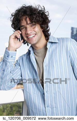 Hispanic male talking on cell phone View Large Photo Image Stock Image - Hispanic male talking on cell phone. Fotosearch