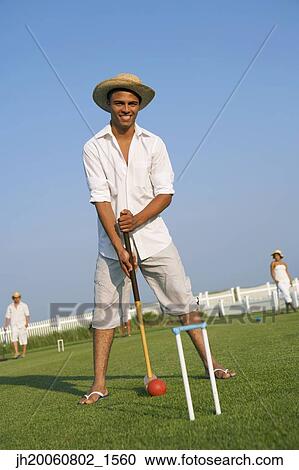 Hispanic man playing croquet View Large Photo Image Stock Image - Hispanic man playing croquet. Fotosearch