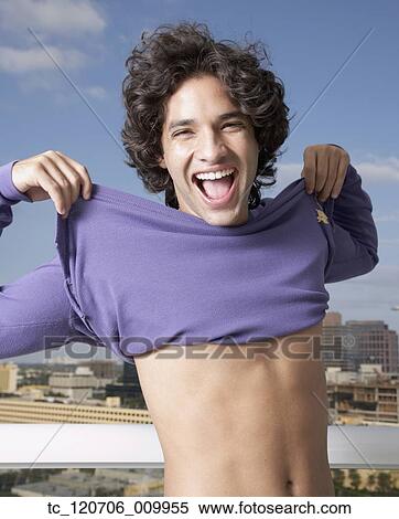 Hispanic man pulling up shirt View Large Photo Image Stock Photography - Hispanic man pulling up shirt. Fotosearch