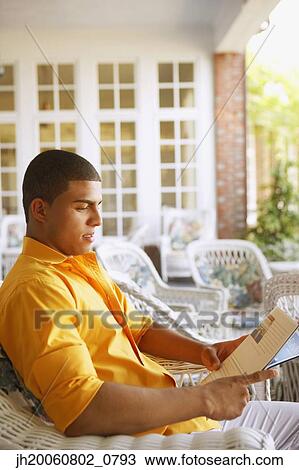 Hispanic man reading magazine View Large Photo Image Stock Image - Hispanic man reading magazine. Fotosearch
