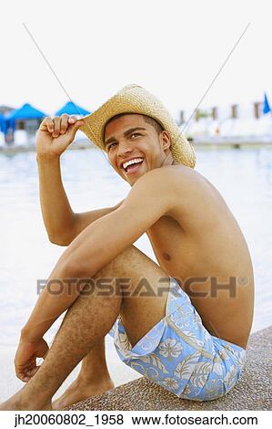 Hispanic man sitting next to swimming pool View Large Photo Image Stock Photo - Hispanic man sitting next to swimming pool. Fotosearch