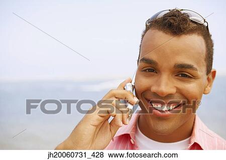 Hispanic man talking on cell phone View Large Photo Image Stock Photo - Hispanic man talking on cell phone. Fotosearch