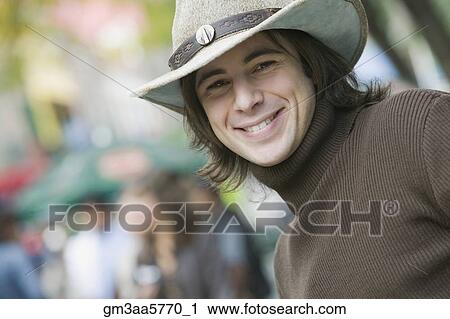 Stock Image - Hispanic man wearing cowboy hat. Fotosearch