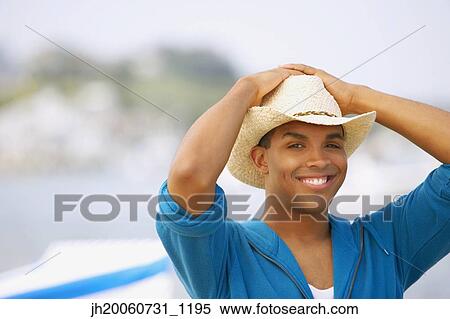 Hispanic man wearing hat at beach View Large Photo Image Stock Photography - Hispanic man wearing hat at beach. Fotosearch