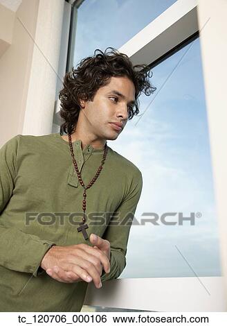 Hispanic man wearing rosary View Large Photo Image Stock Photograph - Hispanic man wearing rosary. Fotosearch