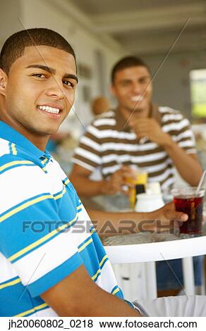 Hispanic men drinking at bar View Large Photo Image Stock Photo - Hispanic men drinking at bar. Fotosearch