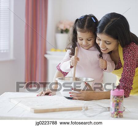 Hispanic mother and daughter mixing batter View Large Photo Image Stock Photo - Hispanic mother and daughter mixing batter. Fotosearch