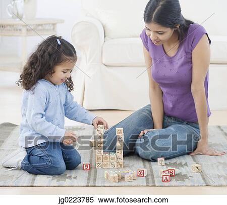 Hispanic mother and daughter playing with blocks View Large Photo Image Stock Photography - Hispanic mother and daughter playing with blocks. Fotosearch