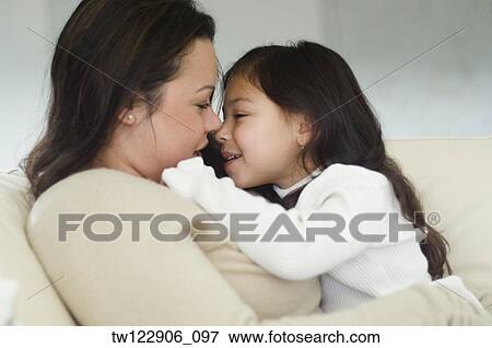 Hispanic mother and daughter smiling at each other View Large Photo Image Stock Photo - Hispanic mother and daughter smiling at each other. Fotosearch