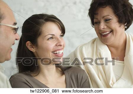 Hispanic parents and adult daughter laughing View Large Photo Image Stock Image - Hispanic parents and adult daughter laughing. Fotosearch