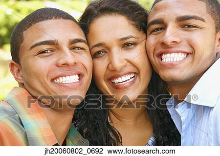 Stock Image - Hispanic siblings hugging. Fotosearch