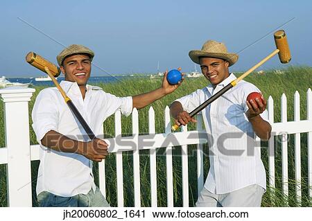 Hispanic twin brothers holding croquet mallets View Large Photo Image Stock Image - Hispanic twin brothers holding croquet mallets. Fotosearch