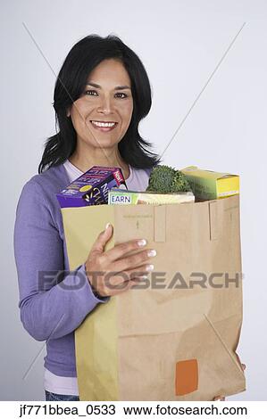 Hispanic woman carrying grocery bag View Large Photo Image Stock Image - Hispanic woman carrying grocery bag. Fotosearch