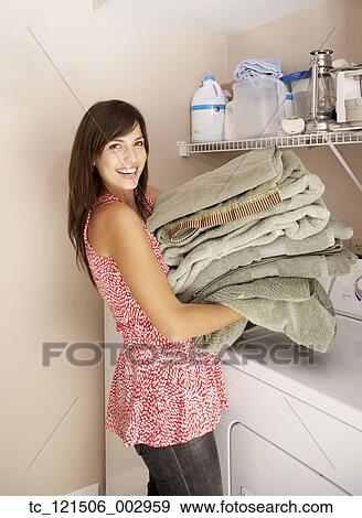 Hispanic woman doing laundry View Large Photo Image Stock Photo - Hispanic woman doing laundry. Fotosearch