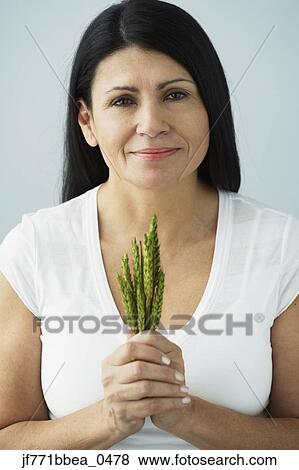 Hispanic woman holding bunch of grain View Large Photo Image Stock Photo - Hispanic woman holding bunch of grain. Fotosearch